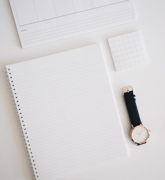 Photo by Marissa Grootes round analog watch with black leather strap on top of white wooden surface